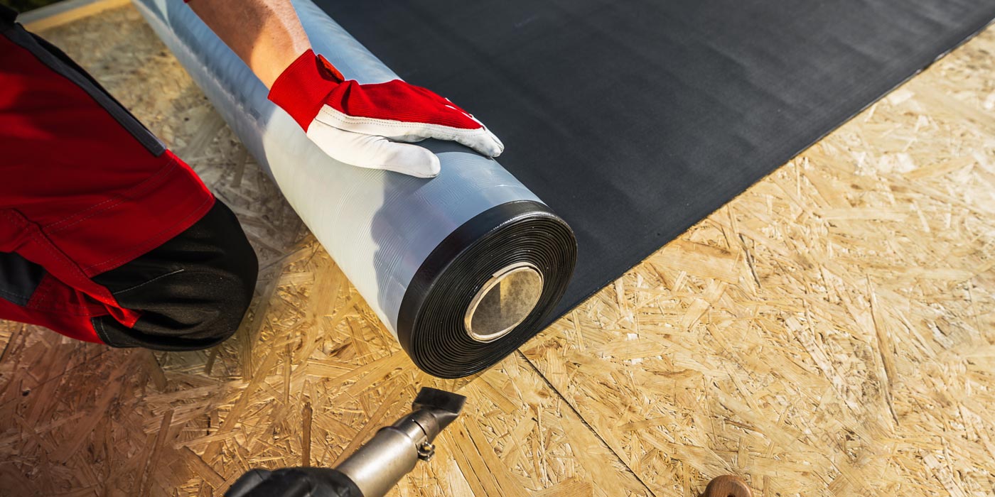 A roofing expert applying Roofing Film during a roof installation